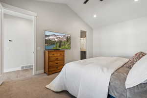 Carpeted bedroom with recessed lighting, high vaulted ceiling, ensuite bath, and a ceiling fan