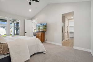Bedroom featuring light colored carpet, lofted ceiling, a spacious closet, recessed lighting, and ceiling fan
