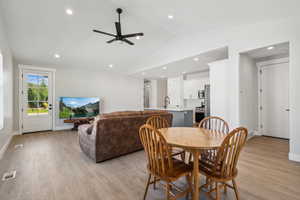 Dining room with light wood-style flooring, recessed lighting, lofted ceiling, and a ceiling fan