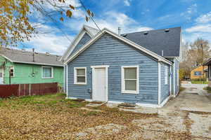 Rear view of property with a shingled roof