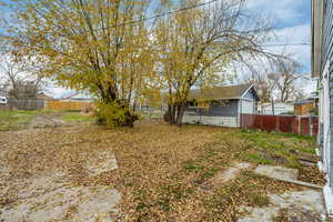 Fenced backyard featuring an outdoor structure