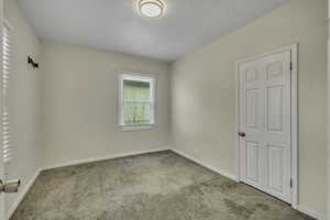 Spare room with carpet floors and baseboards