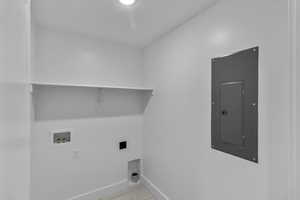 Laundry room featuring light tile patterned floors, electric panel, washer hookup, and hookup for an electric dryer