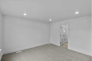 Spare room featuring light carpet and recessed lighting