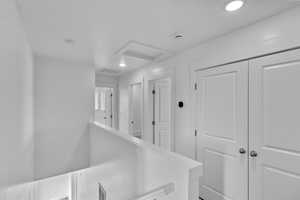 Hallway featuring recessed lighting and attic access