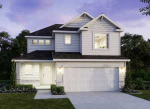 Craftsman-style home with roof with shingles, a garage, driveway, and a front yard