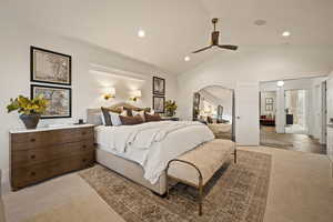 Bedroom with light carpet, vaulted ceiling, a ceiling fan, and recessed lighting