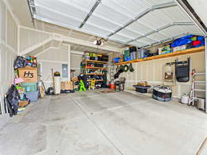 Garage featuring electric panel and a garage door opener