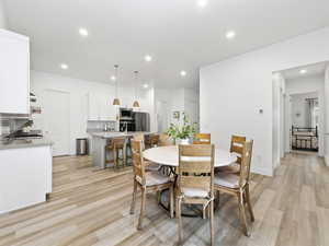 Dining space featuring light wood-type flooring and recessed lighting