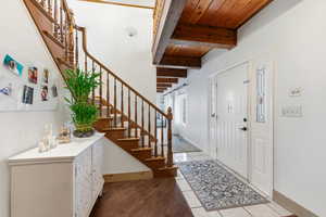 Welcoming foyer with wood staircase.