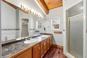 Full bathroom #2  featuring a shower stall, double vanity, dark wood-type flooring, wood ceiling, and lofted ceiling