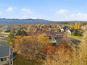 Captures surrounding homes and valley landscape.