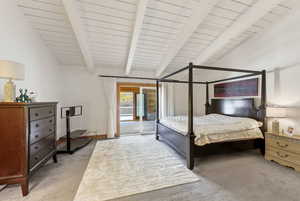 Vaulted ceiling suite with beams. View toward ensuite & sliders.