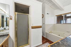 Large jetted tub with sunlight. Tile shower & brass trim.