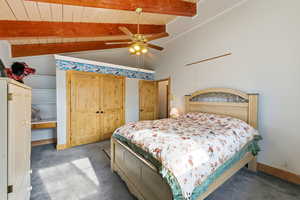 Bedroom #2 with ceiling fan, a closet, carpet, a wood ceiling with exposed beams, and high vaulted ceiling