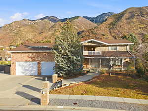 Aerial hero shot showcasing dramatic mountains behind the home.