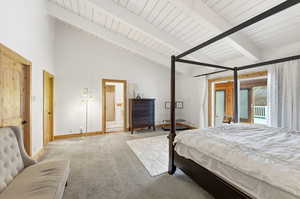 Vaulted ceiling suite with beams.Primary bedroom with beam ceiling, high vaulted ceiling, and access to outside