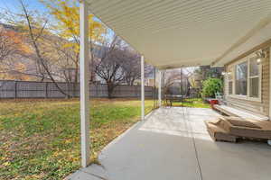 Backyard – Deck ViewInitial deck and yard layout. Fenced backyard featuring a patio area and a trampoline