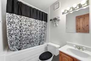 Full bath with vanity and shower / tub combo with curtain. Inside Music Studio withHuge vaulted room w/ skylights, with a fireplace