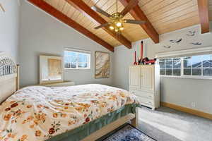 Bedroom #2  with light colored carpet, wooden ceiling, multiple windows, and ceiling fan