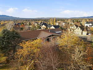 Angle showing second-story balcony and backyard trees.