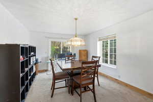Adjacent flexible-use space.. Formal Dining space featuring light colored carpet and baseboards