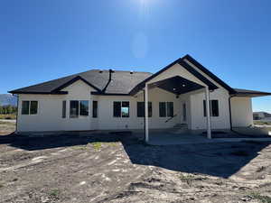 Rear view of property with a covered patio area