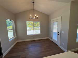Dining area featuring a chandelier and lofted ceiling