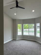 Master bedroom with vaulted ceiling and fan.