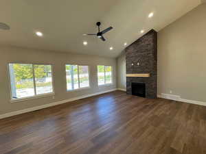 Large great room with high vaulted ceiling, recessed lighting, ceiling fan, LVP wood-style floors, and a gas fireplace