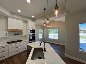 Vented range, with cooking faucet above stove top, spacious dining area.