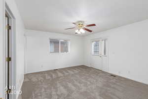 Spare room with carpet floors and ceiling fan