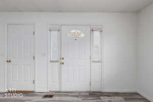 Foyer with wood finished floors