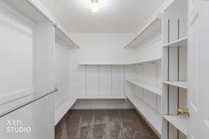 Walk in closet with dark carpet