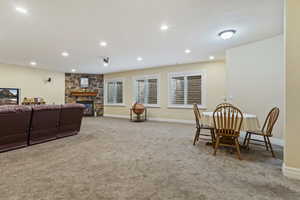 Family room featuring light carpet, a fireplace, and recessed lighting