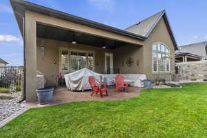 Back of property with stucco siding, ceiling fan, and a patio all patio equipment included