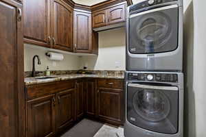 Washroom featuring cabinet space and stacked washer / drying machine Maytag Maxima included