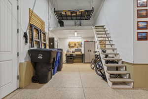 Garage with a garage door opener oversized with tandum 2 car on one side or workshop