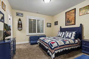 Bedroom 2, carpeted bedroom with baseboards and a textured ceiling