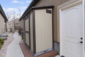 View of home's exterior with a cooling unit and the only allowed storage unit in the complex