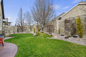 Private fenced backyard with a patio