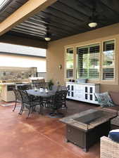 View of patio / builtin outdoor kitchen terrace with area for grilling, outdoor dining area, a ceiling fan, and outdoor lounge area