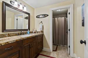Full Bathroom with curtained shower and vanity