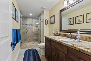 3/4 bathroom with vanity, a shower stall, recessed lighting, and light tile patterned floors