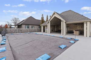 Clubhouse community pool featuring a patio area