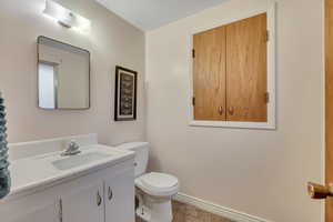 Primary bathroom with vanity and toilet...and a very large/deep built-in storage cabinet.