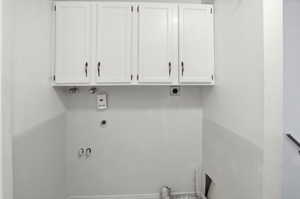 Laundry area with hookup for an electric dryer and cabinet space