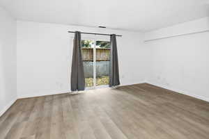 Spare room with light wood-style floors and baseboards