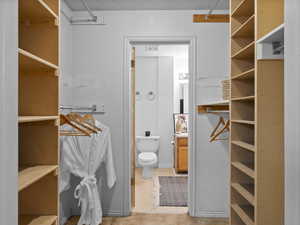 Walkthrough closet from Primary bedroom to bathroom