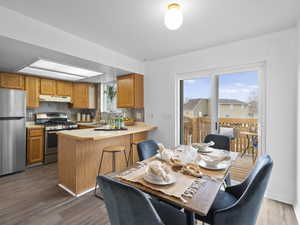 Dining space featuring dark wood-style floors